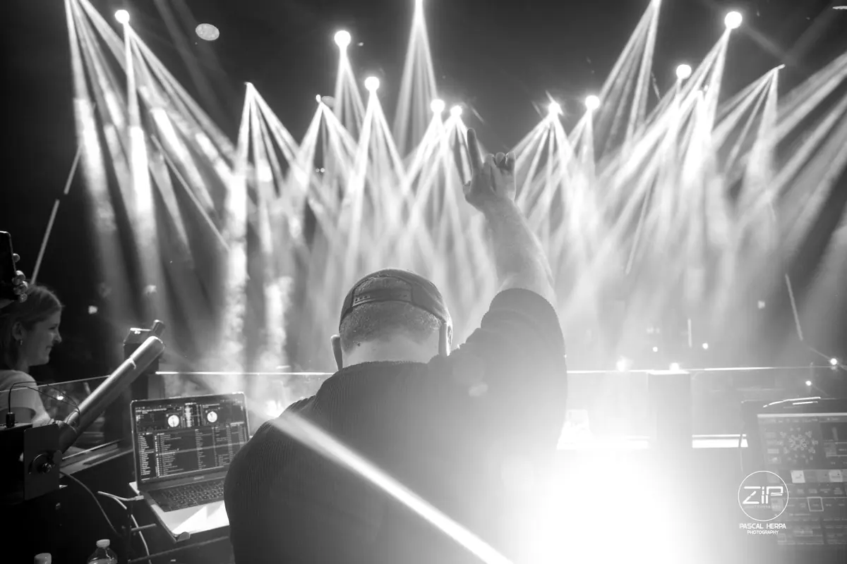 Le DJ du Zip Club de dos face aux projecteurs, en noir et blanc